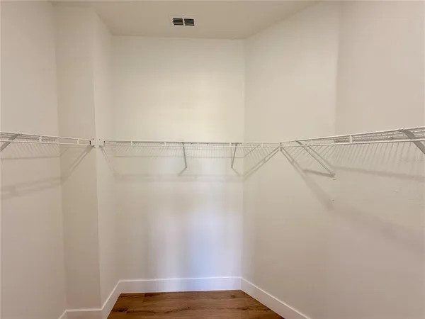 a view of a livingroom with a ceiling fan and wooden floor