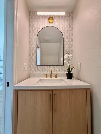 a view of wooden floor and a chandelier fan in a room