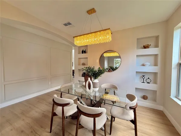a kitchen with a sink a stove and a chandelier