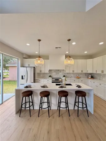 a living room with furniture a flat screen tv and a floor to ceiling window