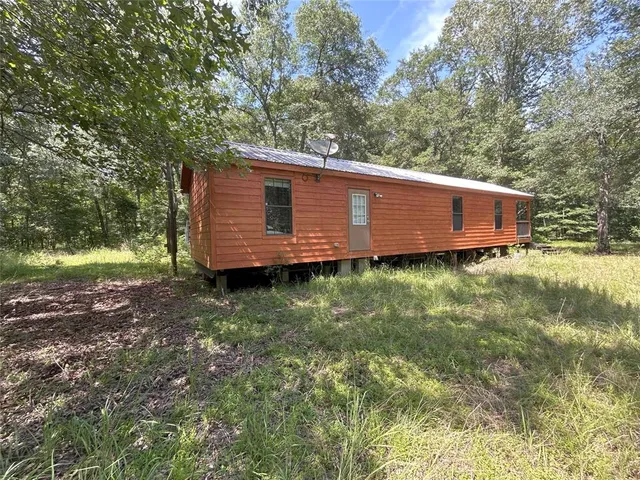 a view of a backyard with large trees