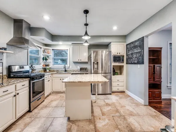 a kitchen with a sink stainless steel appliances and cabinets
