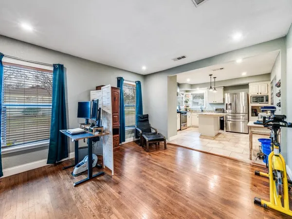 a view of a kitchen with dining table and chairs