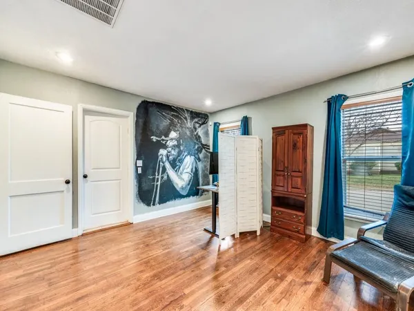a view of room with wooden floor and closet