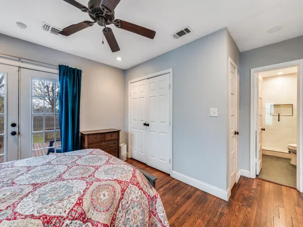 a bedroom with a bed and a large mirror