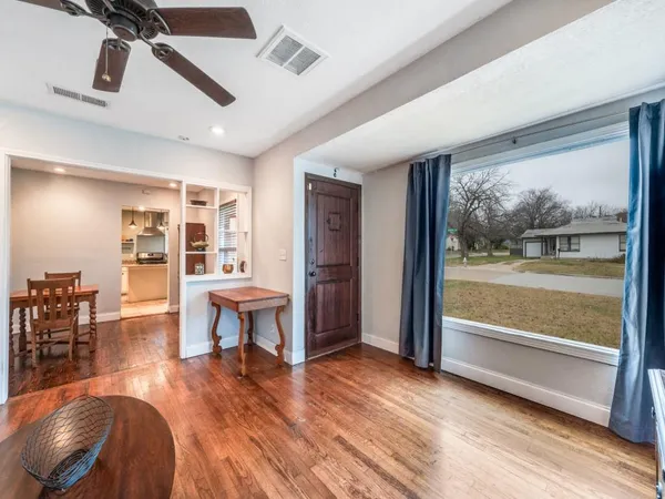 a view of a livingroom with furniture and a floor to ceiling window