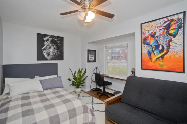 a bedroom with a bed and furniture with window