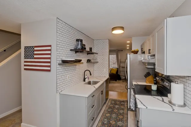 a kitchen with a sink and refrigerator