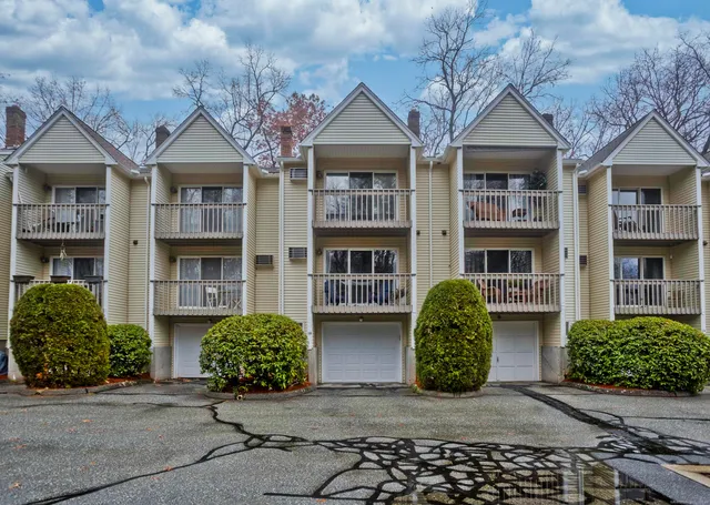 front view of a brick house with a small yard