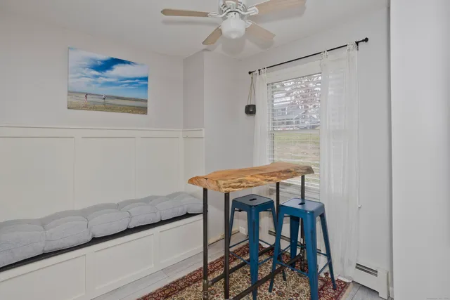 a room with chandelier fan and wooden floor