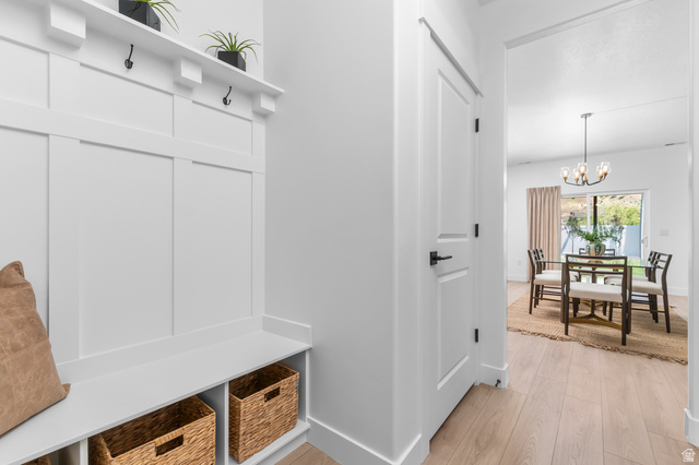 1352 West 2350 South, Unit 18 Perry, UT 84302 - Photo 10 of 26 Built-in mudroom bench with board and batten wall treatment, integrated storage cubbies, and overhead shelving featuring integrated coat hooks