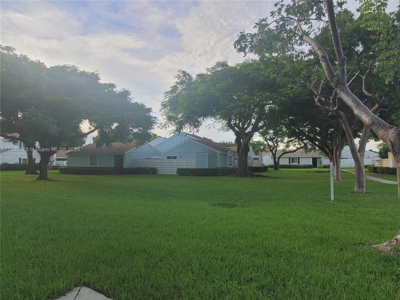 13814 Southwest 149th Cir Lane, Unit 362 Miami, FL 33186 - Photo 2 of 19 a backyard of a house with lots of green space and lake view