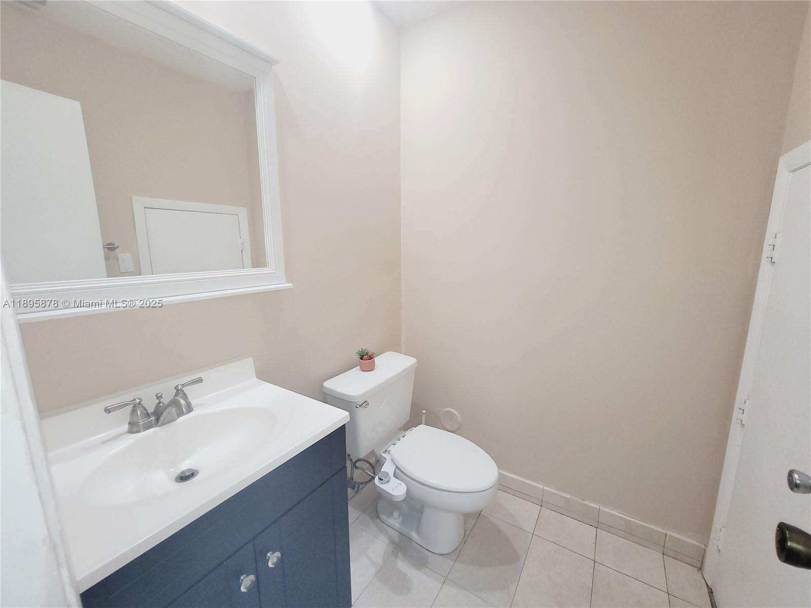 13814 Southwest 149th Cir Lane, Unit 362 Miami, FL 33186 - Photo 6 of 19 a bathroom with a toilet a sink and mirror
