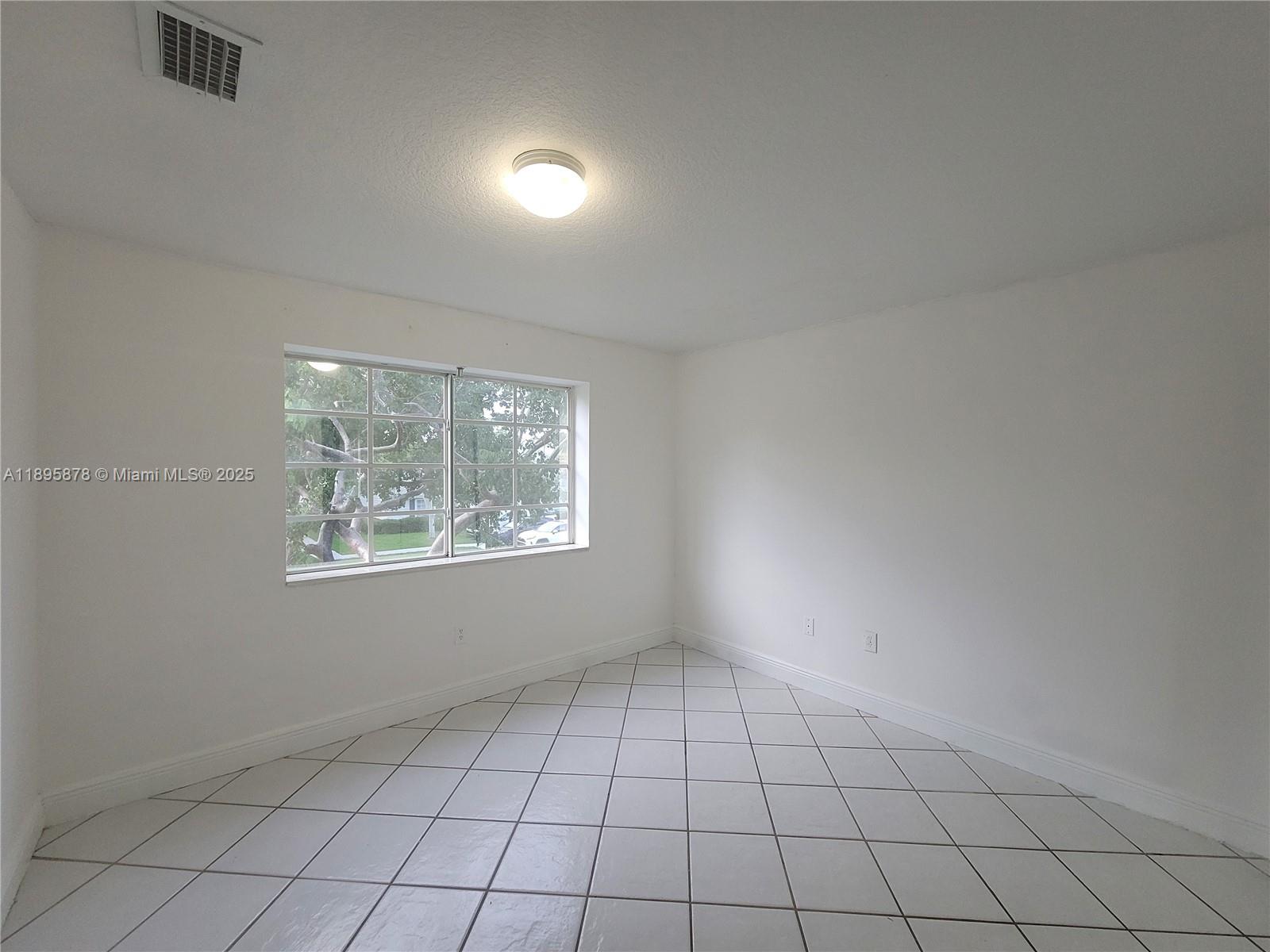 13814 Southwest 149th Cir Lane, Unit 362 Miami, FL 33186 - Photo 7 of 19 a view of an empty room and window