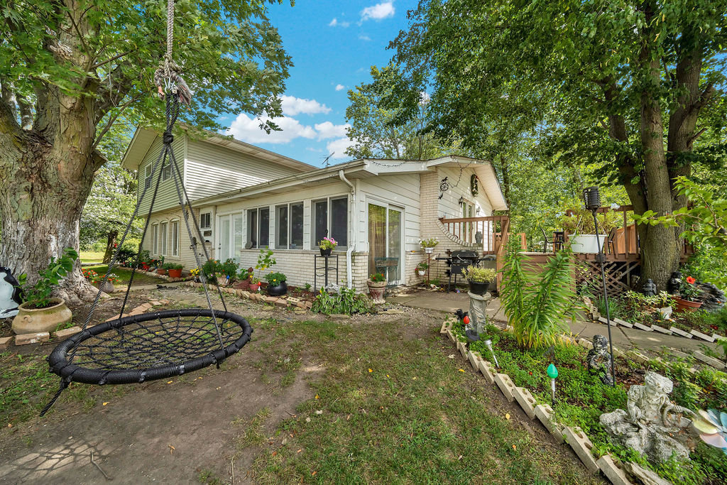 a view of a big house with fountain in a yard