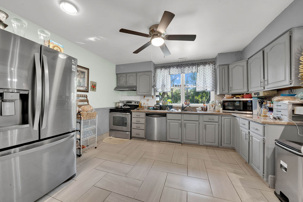 7245 West Dralle Road Monee, IL 60449 - Photo 5 of 73 a kitchen with granite countertop a refrigerator a sink a stove top oven and cabinetry