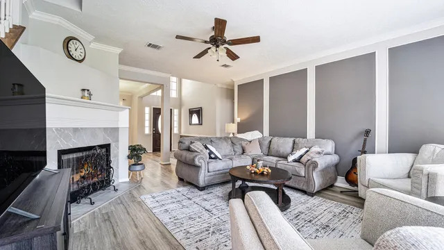a living room with furniture and a fireplace