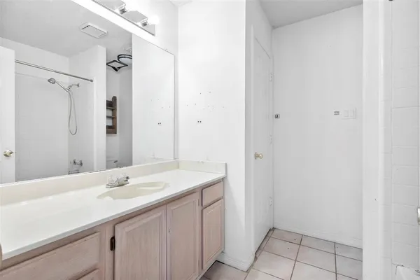 a view of a house with a small yard plants and large tree
