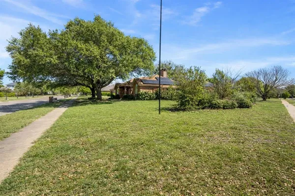 a view of a large garden with large trees