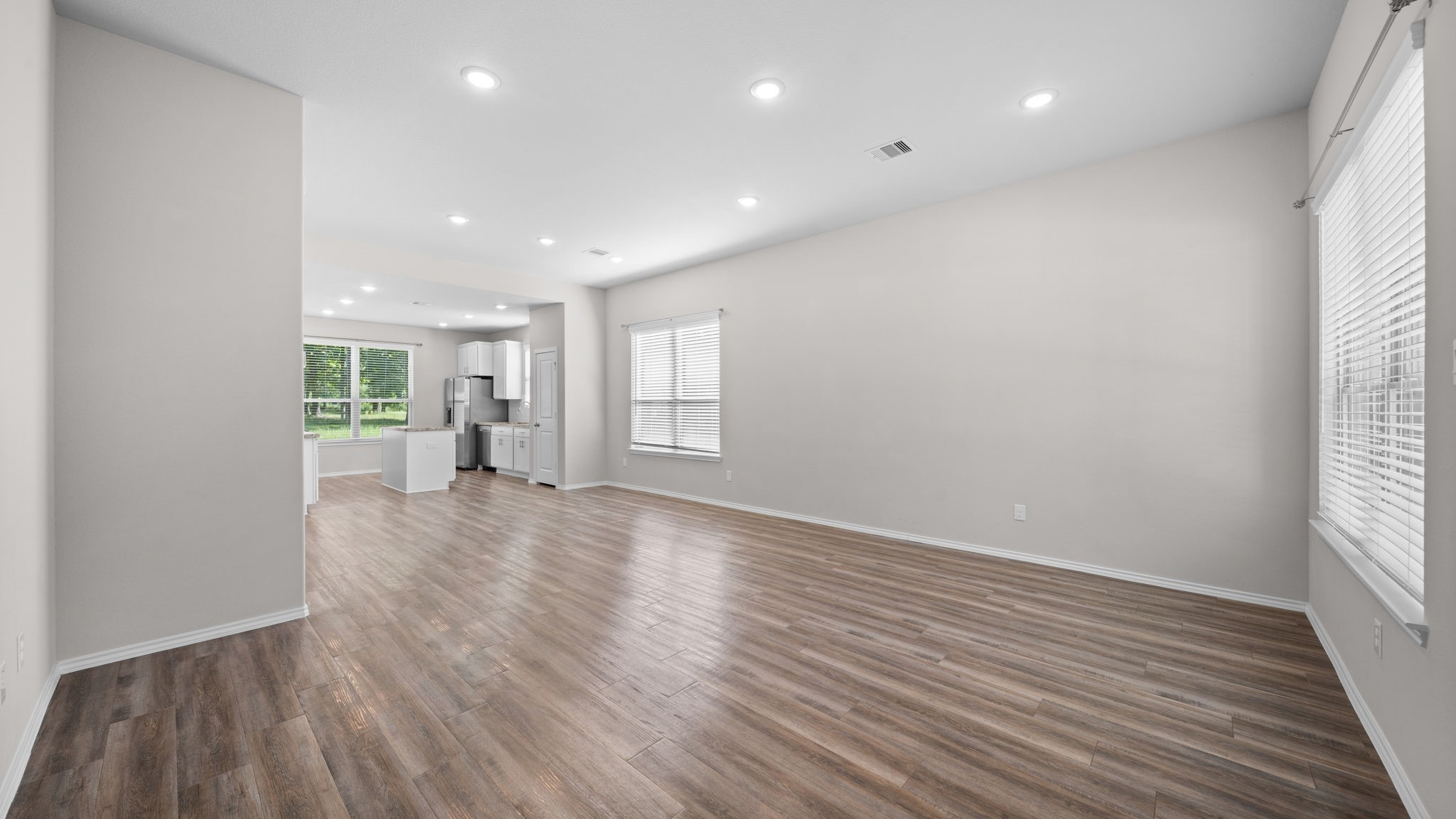 18140 Mail Rte Road Montgomery, TX 77316 - Photo 4 of 26 Step inside to an open-concept living space featuring durable wood-look flooring and abundant natural light.