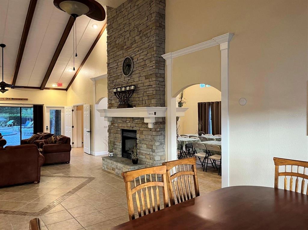 10264 Northeast 28th Loop Silver Springs, FL 34488 - Photo 18 of 44 a living room with furniture a fireplace and a table