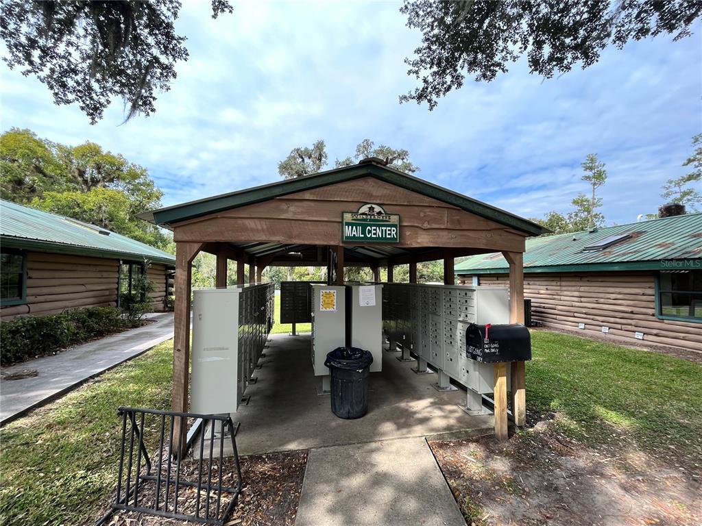 10264 Northeast 28th Loop Silver Springs, FL 34488 - Photo 29 of 44 a view of a patio with table and chairs under an umbrella