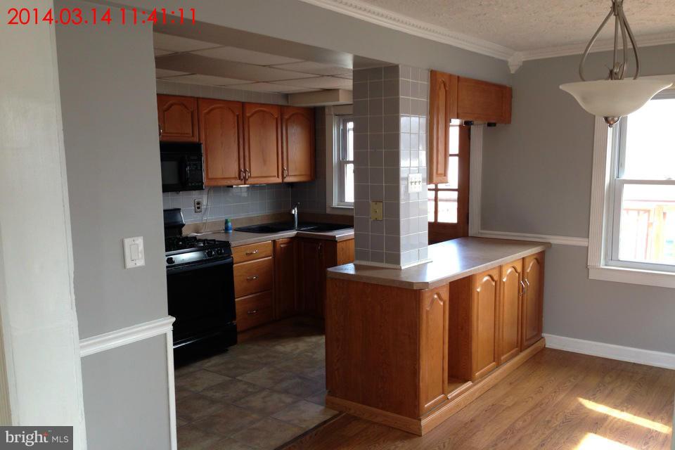 314 Stemmers Run Road Baltimore, MD 21221 - Photo 3 of 13 a kitchen with stainless steel appliances granite countertop a sink stove and refrigerator