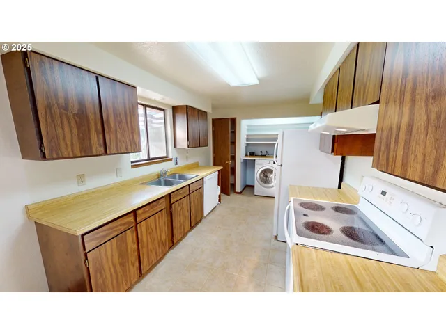 a open kitchen with stainless steel appliances granite countertop a sink and a refrigerator