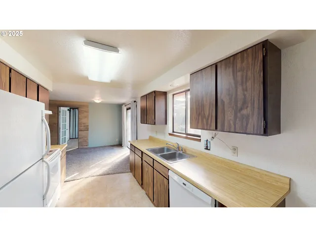 a kitchen with a refrigerator and a sink
