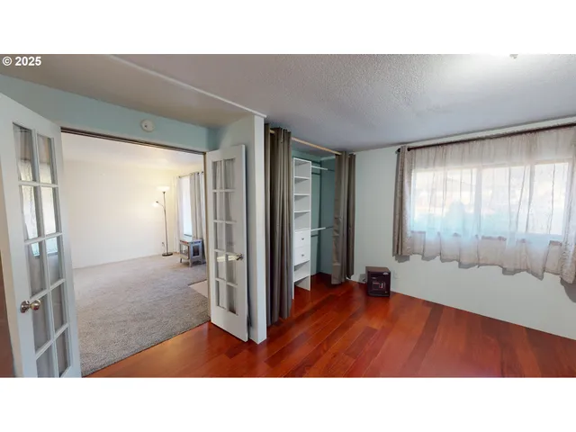 a room with a bed and large window