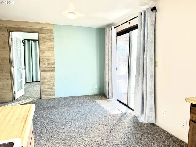 an empty room with windows and closet