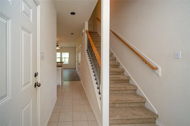 a view of a hallway with wooden floor and entryway