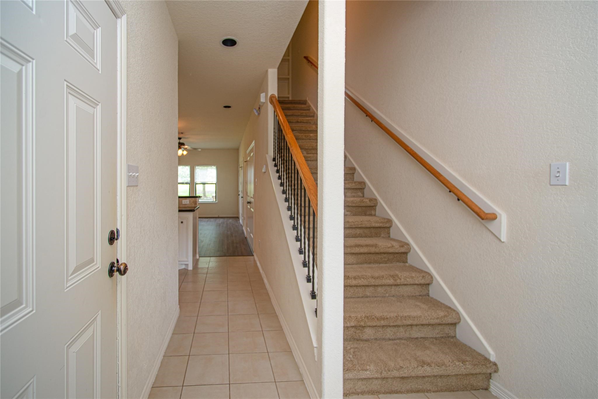 1426 April Villas, Unit A Conroe, TX 77356 - Photo 3 of 8 a view of a hallway with wooden floor and entryway