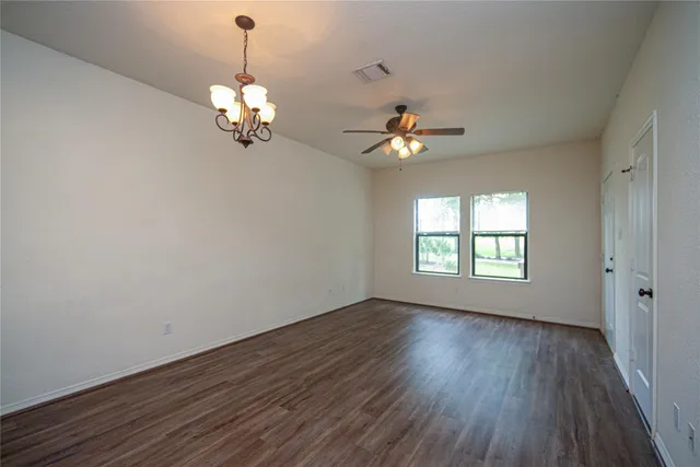 a view of an room with wooden floor and chandelier