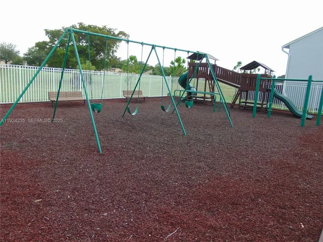 a view of a house with pool fire pit and chairs