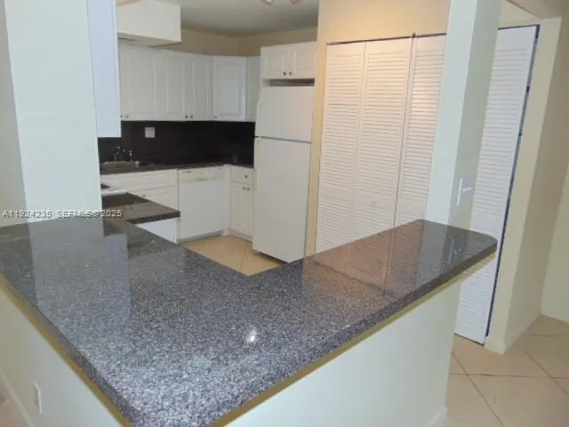 a kitchen with a sink a counter top space and cabinets