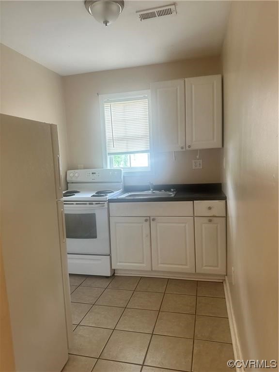 Undisclosed Address Richmond, VA 23222 - Photo 14 of 15 a kitchen with a sink a stove and cabinets