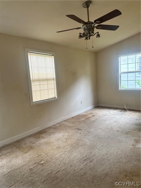 Undisclosed Address Richmond, VA 23222 - Photo 5 of 15 an empty room with a chandelier fan and windows