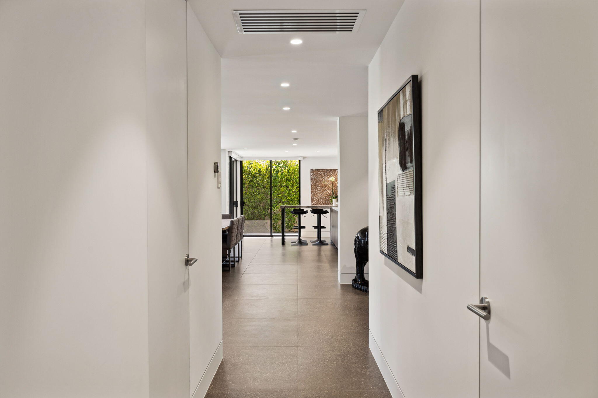 20 Lafayette Drive Rancho Mirage, CA 92270 - Photo 19 of 48 a view of a hallway with wooden floor and a living room