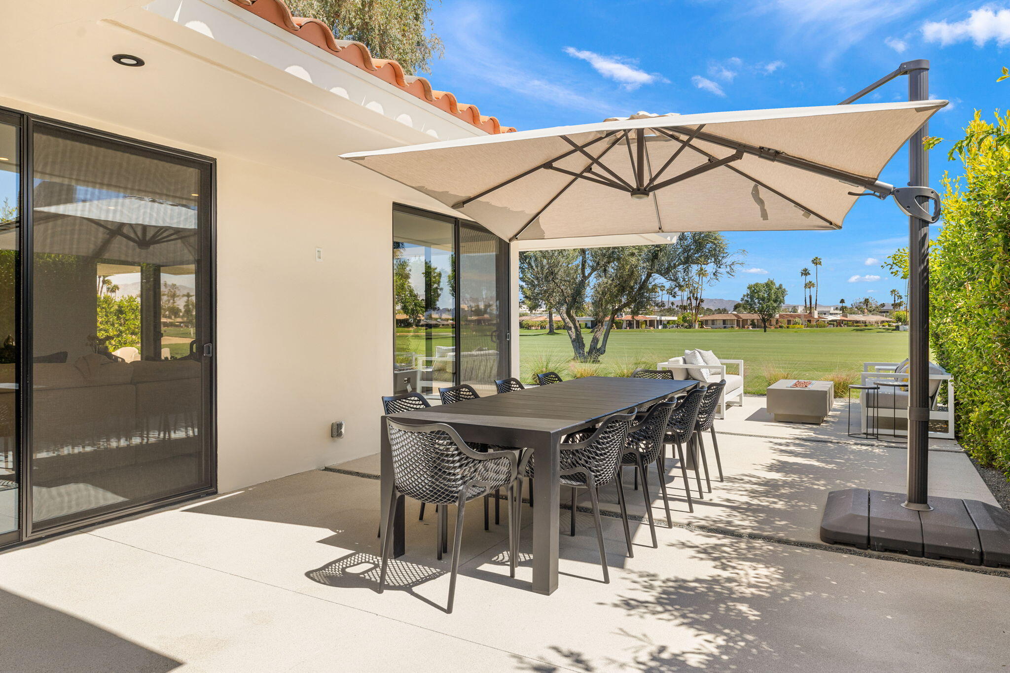 20 Lafayette Drive Rancho Mirage, CA 92270 - Photo 41 of 48 a view of a patio with a table and chairs under an umbrella