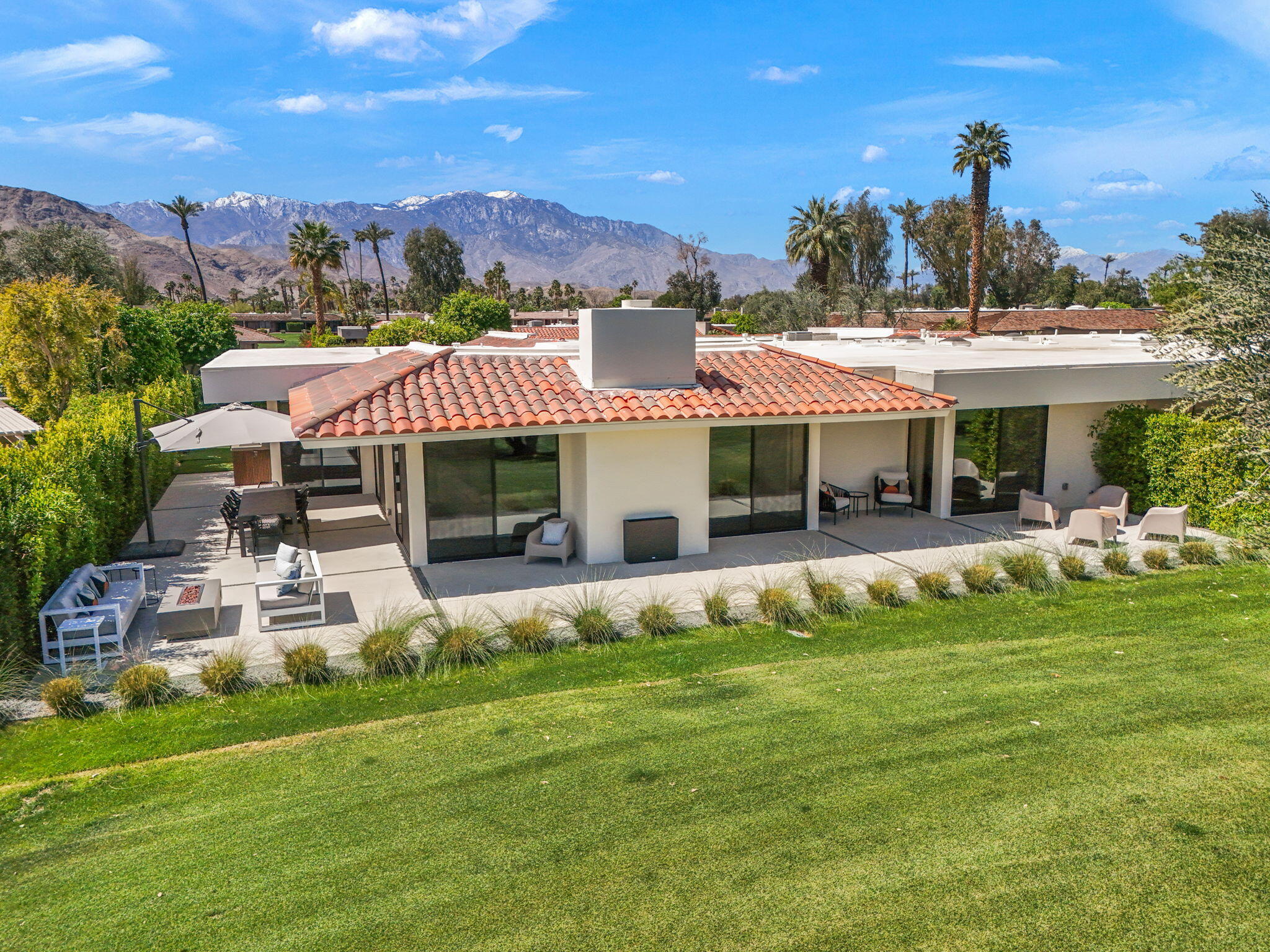 20 Lafayette Drive Rancho Mirage, CA 92270 - Photo 48 of 48 a front view of a house with a yard table and chairs