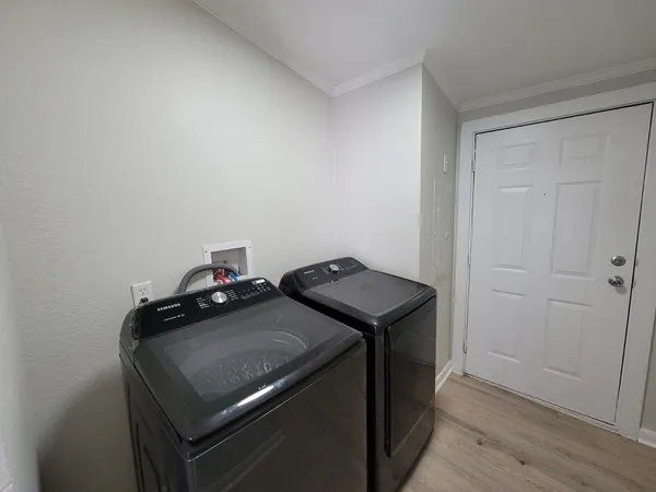 a view of storage and utility room with wooden floor