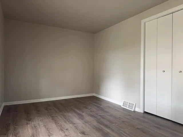 a view of an empty room and wooden floor