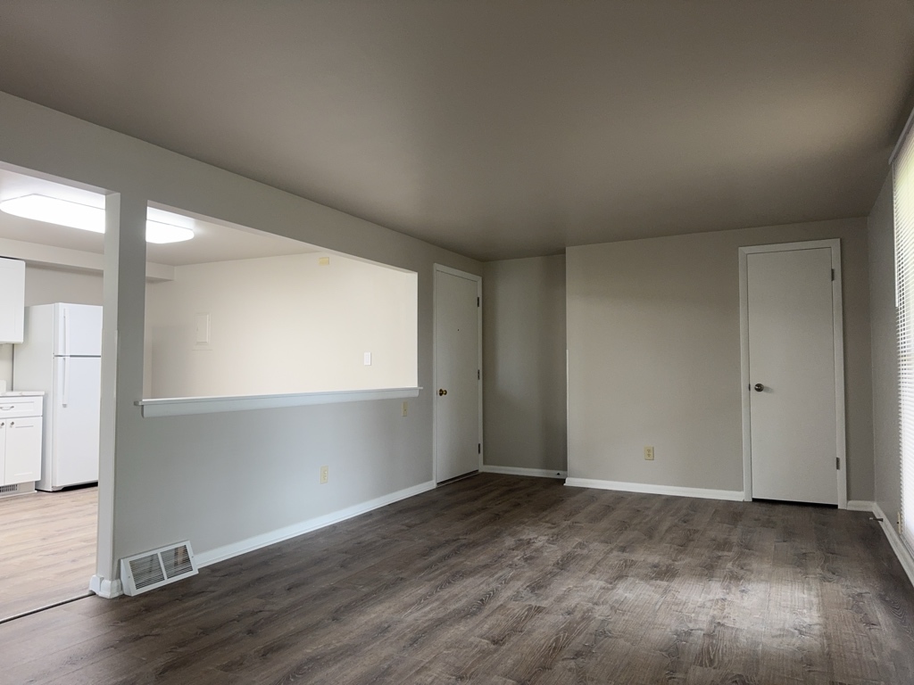 418 Beloit Street, Unit 6 Walworth, WI 53184 - Photo 3 of 23 an empty room with wooden floor and windows