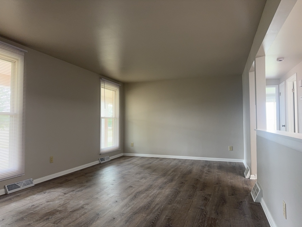 418 Beloit Street, Unit 6 Walworth, WI 53184 - Photo 4 of 23 an empty room with wooden floor and windows