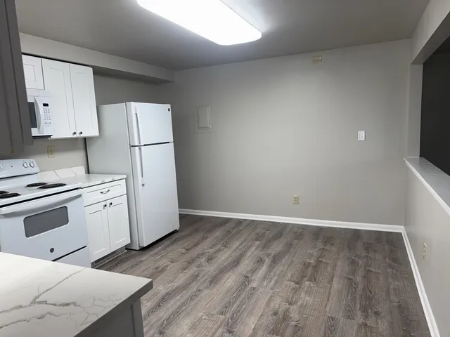 a kitchen with a white cabinets and white appliances