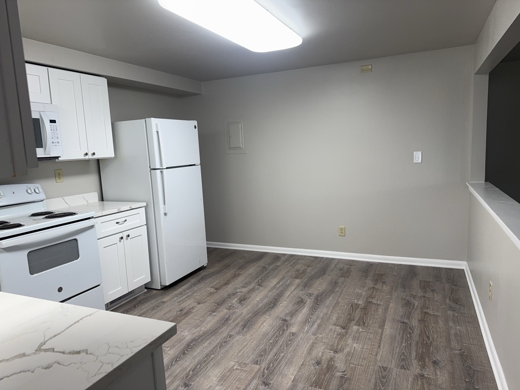 418 Beloit Street, Unit 6 Walworth, WI 53184 - Photo 6 of 23 a kitchen with a white cabinets and white appliances