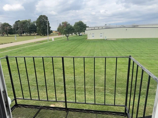 a view of a green yard next to a yard