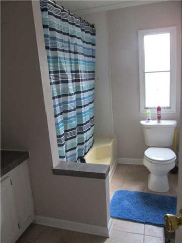 2188 CCC Road McEwen, TN 37101 - Photo 7 of 16 a bathroom with a toilet and a shower curtain