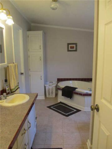 2188 CCC Road McEwen, TN 37101 - Photo 9 of 16 a bathroom with a granite countertop sink and a mirror